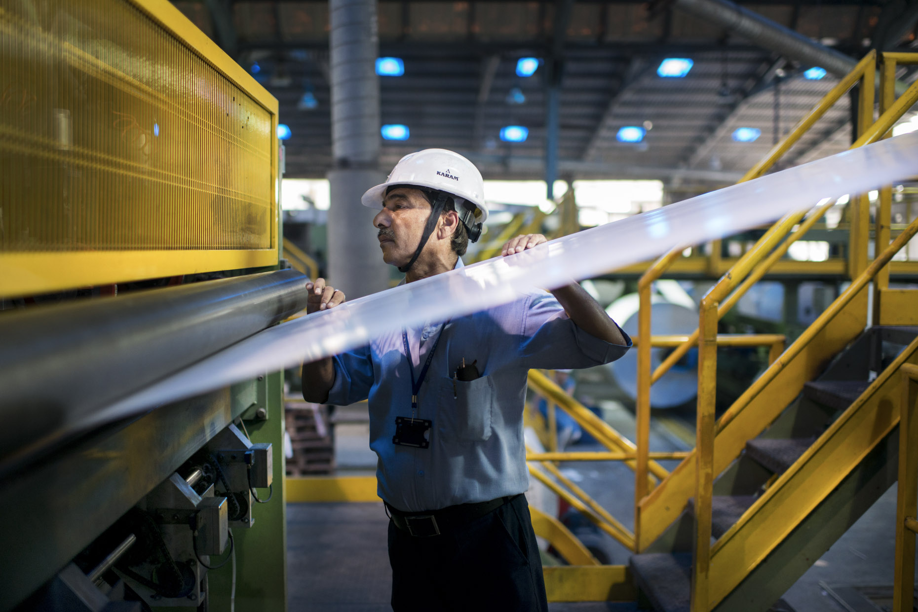 Century Pulp & Paper Factory campaign by Photographer Stefen Chow | Birla Group | Brand Book | Advertising | Commercial | Industrial Photography | Worker Inspecting Paper |Century Pulp & Paper Factory | India | Asia